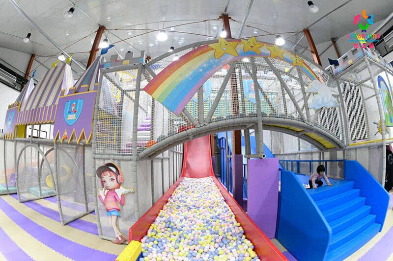 Interactive ball kingdom zone with blaster towers and ball pool in a commercial indoor playground